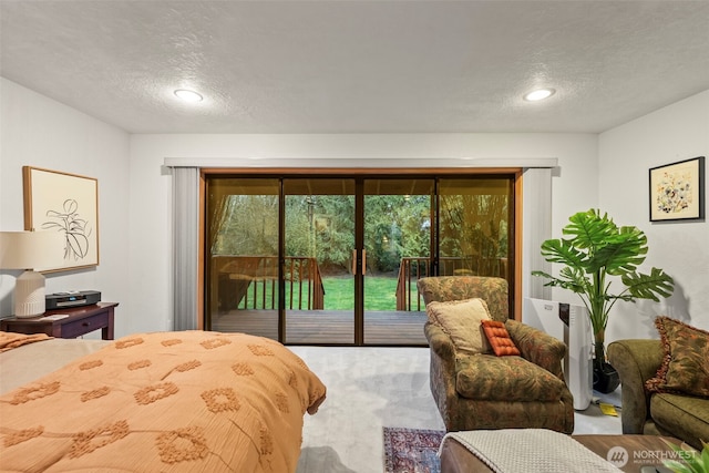 bedroom featuring access to outside and a textured ceiling