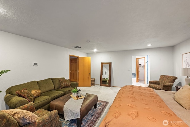 carpeted living area with visible vents and recessed lighting