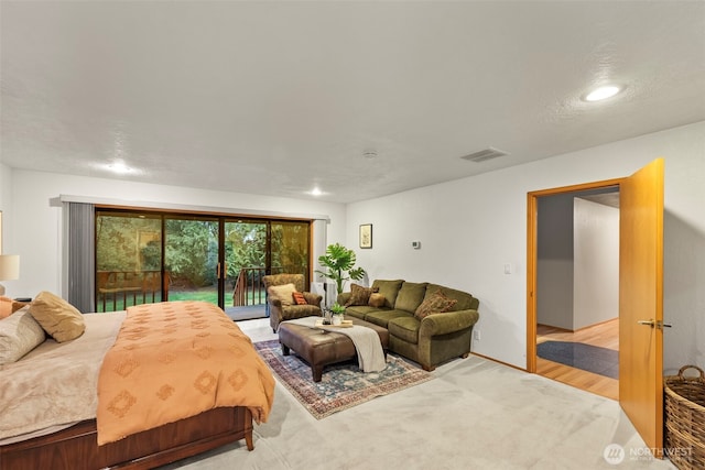 bedroom featuring access to exterior, light colored carpet, and visible vents