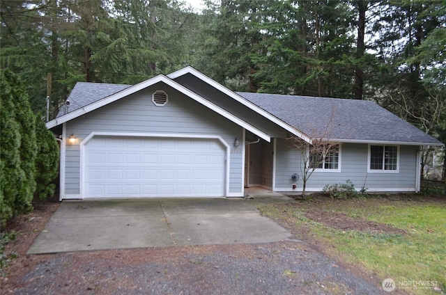 ranch-style home featuring an attached garage, driveway, and roof with shingles