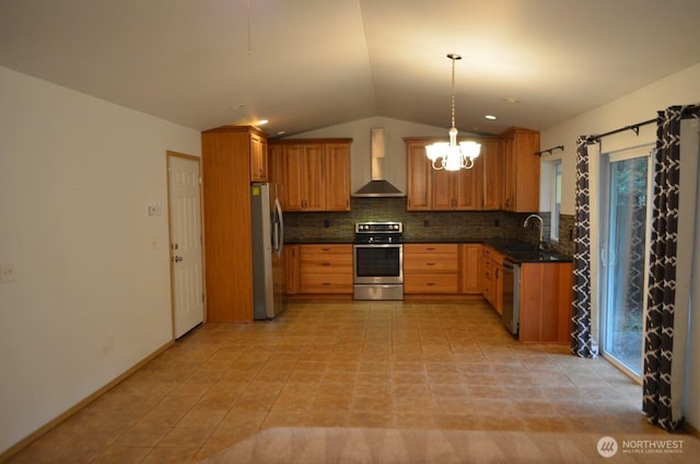 kitchen featuring decorative backsplash, lofted ceiling, stainless steel appliances, wall chimney range hood, and a sink