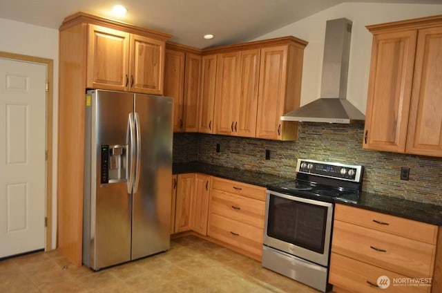 kitchen with recessed lighting, vaulted ceiling, appliances with stainless steel finishes, backsplash, and wall chimney exhaust hood