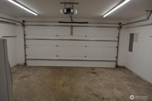 garage with a garage door opener and electric panel