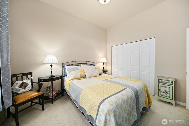 bedroom featuring light carpet, a closet, and vaulted ceiling