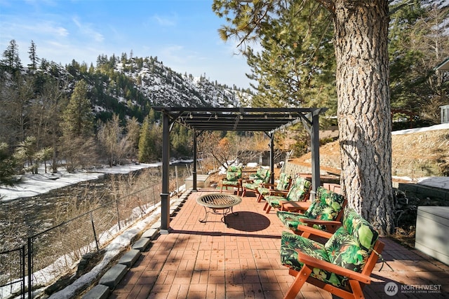 deck with an outdoor fire pit, a patio, fence, and a pergola