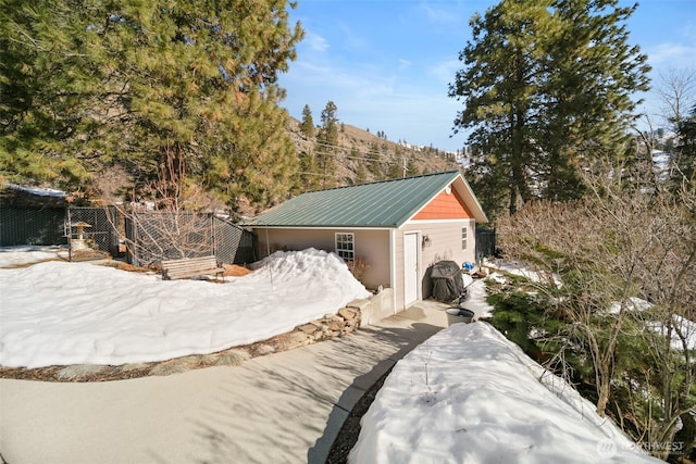 exterior space with an outdoor structure and fence