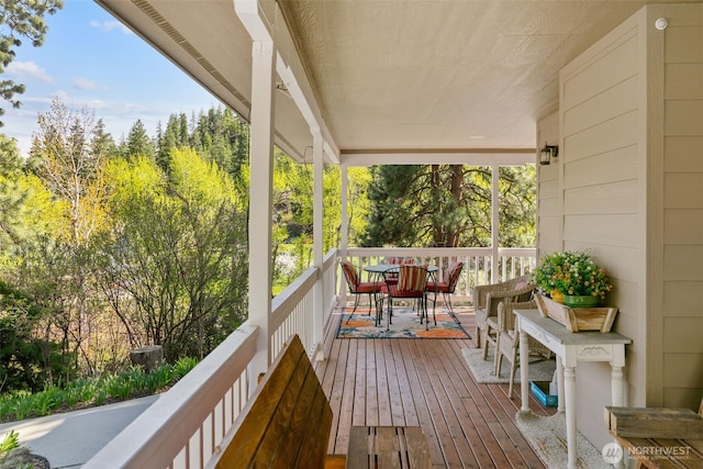 wooden terrace featuring outdoor dining space