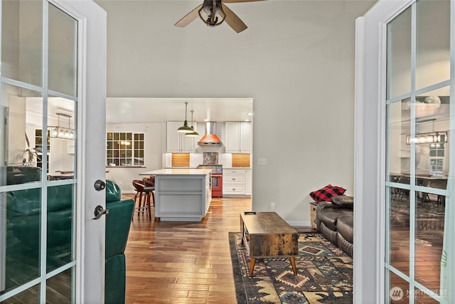 living area featuring light wood finished floors and ceiling fan