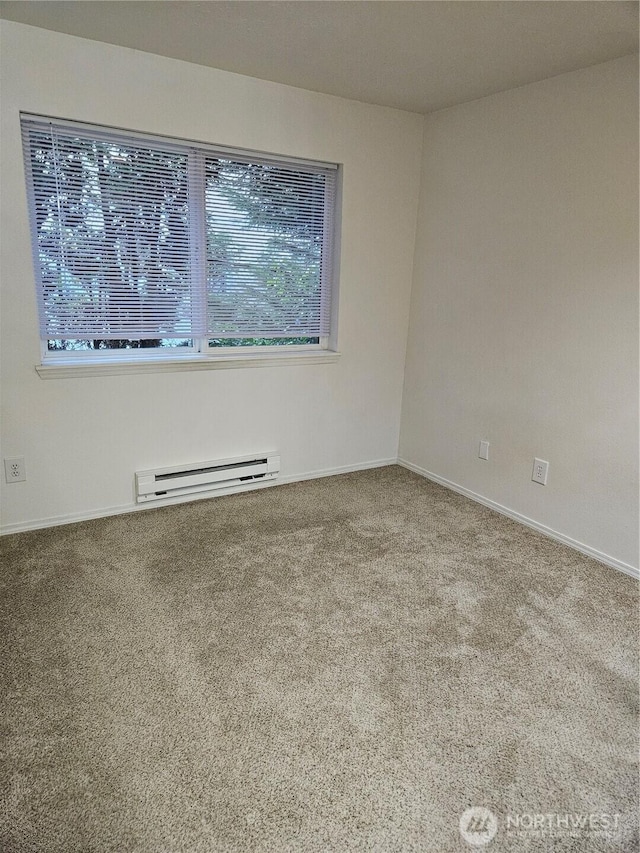 carpeted empty room with plenty of natural light, baseboards, and baseboard heating