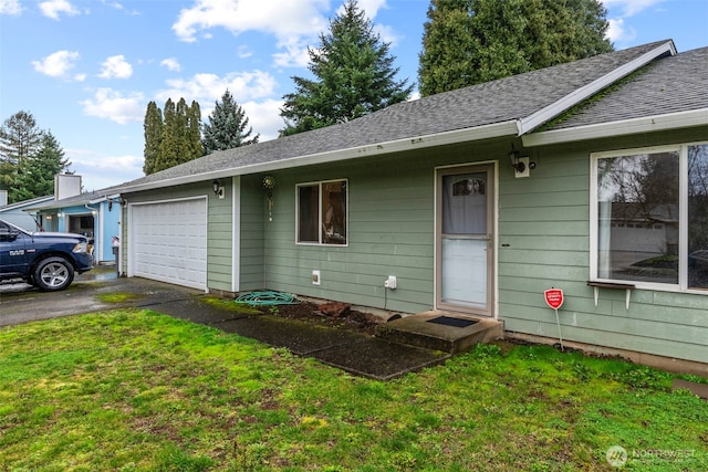 view of front facade featuring aphalt driveway, an attached garage, a front yard, and a shingled roof