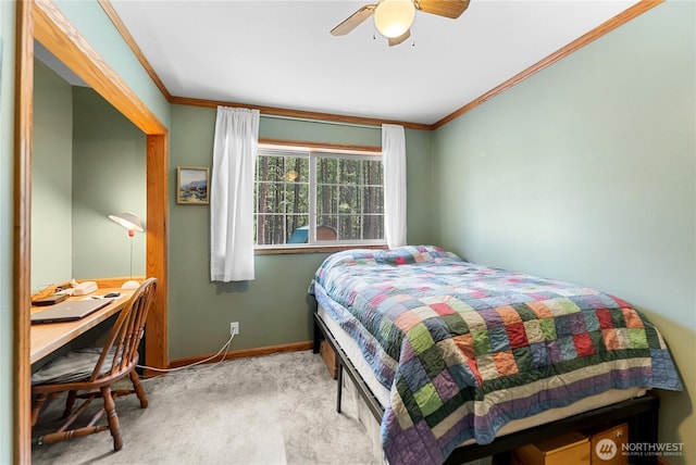 carpeted bedroom with crown molding, baseboards, and ceiling fan