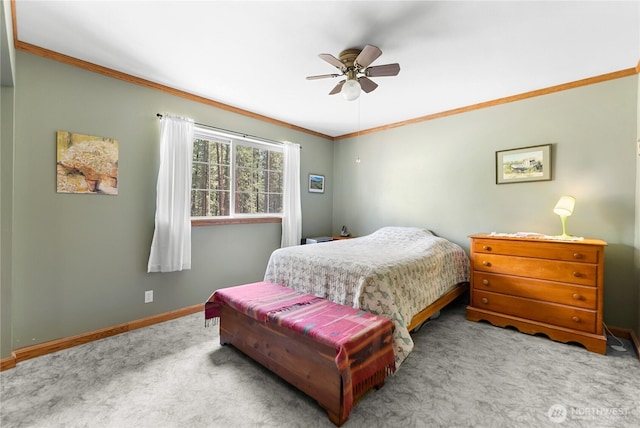 bedroom featuring ceiling fan, crown molding, baseboards, and carpet floors