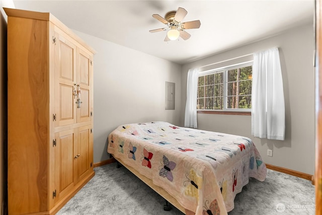 bedroom featuring electric panel, baseboards, light colored carpet, and a ceiling fan