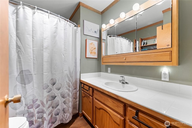 bathroom with vanity, crown molding, toilet, and a shower with shower curtain