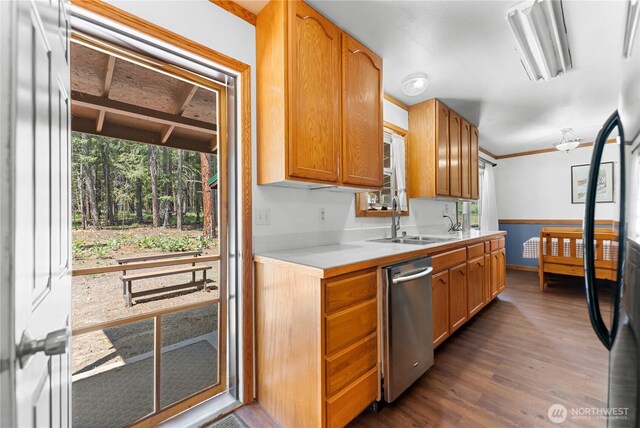 kitchen with a sink, dishwasher, light countertops, ornamental molding, and dark wood-style flooring