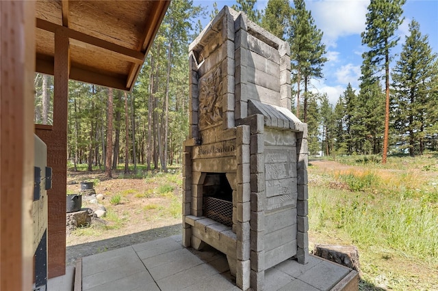 exterior details featuring an outdoor stone fireplace