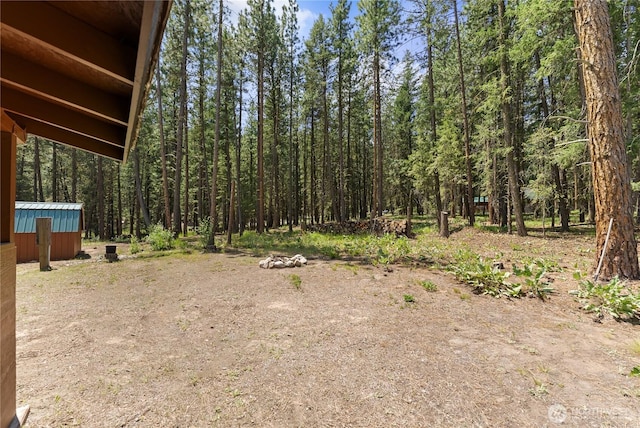 view of yard featuring a wooded view