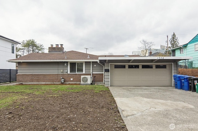 ranch-style house with ac unit, brick siding, fence, a garage, and driveway