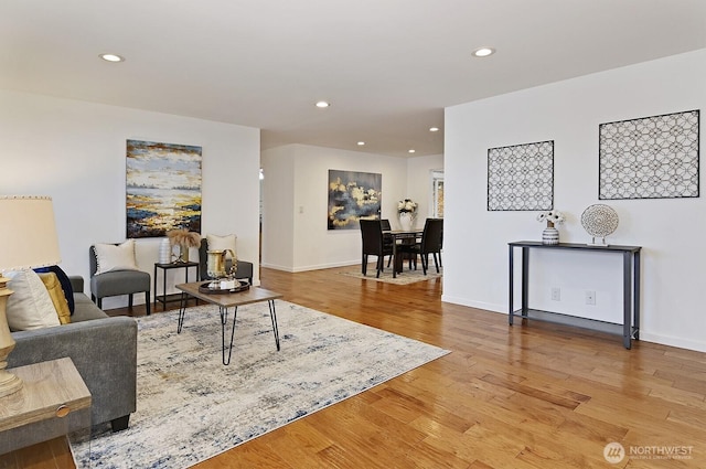 living area featuring recessed lighting, baseboards, and wood finished floors