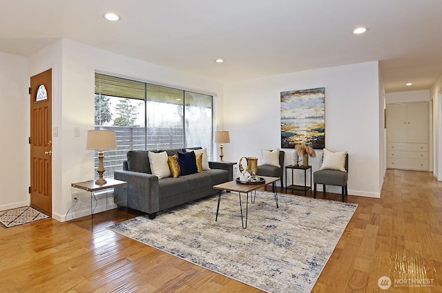 living room with recessed lighting, baseboards, and wood finished floors