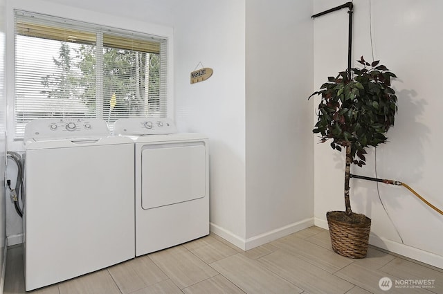 laundry room with laundry area, washer and clothes dryer, and baseboards