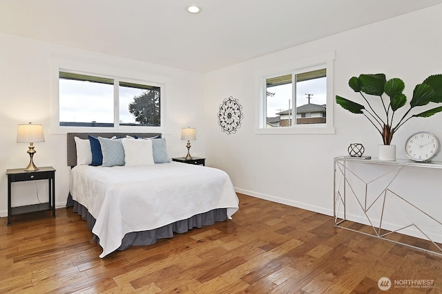 bedroom featuring recessed lighting, wood finished floors, and baseboards