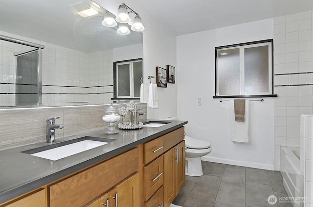 full bathroom with tile walls, a sink, and tile patterned floors