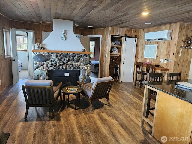 living room featuring wooden ceiling, a wall mounted air conditioner, wooden walls, and a barn door