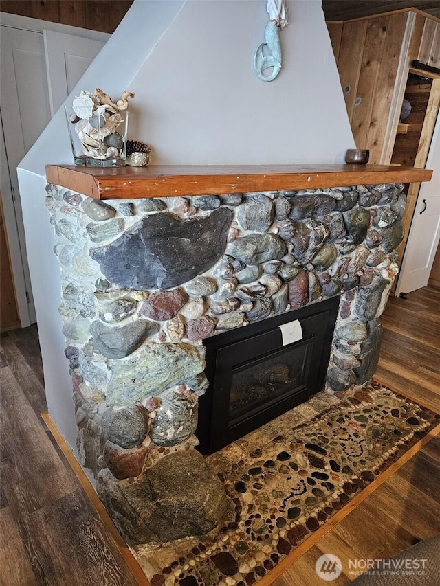 interior details with a fireplace and wood finished floors