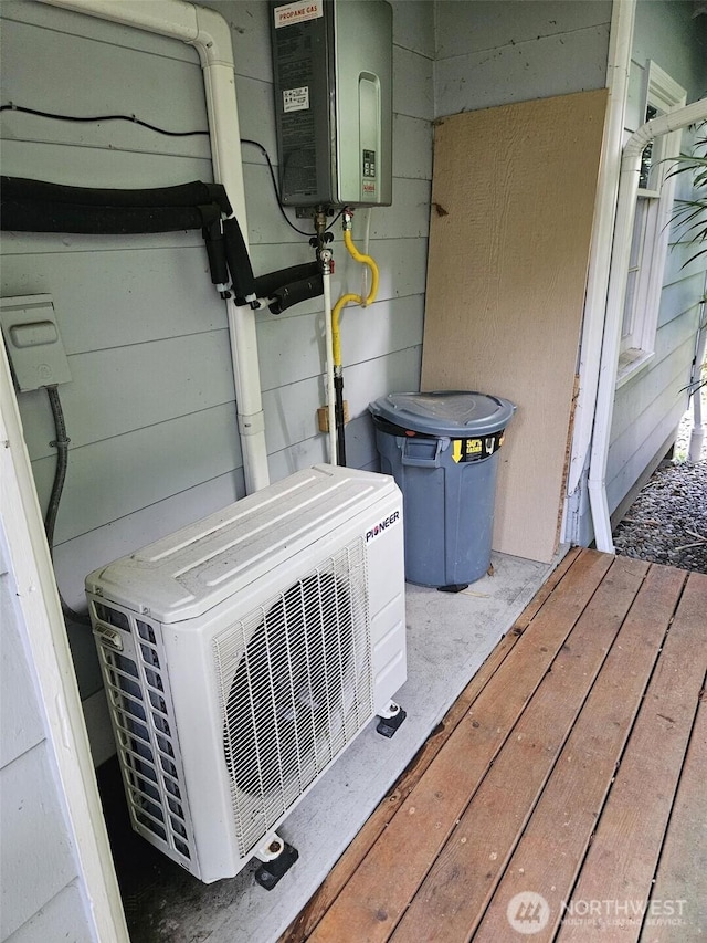 exterior details featuring ac unit and tankless water heater