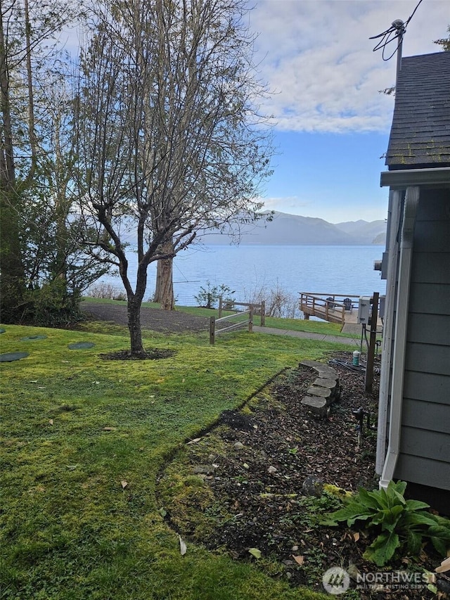 view of yard with a water and mountain view