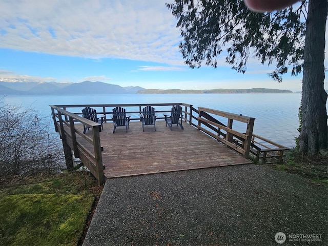 view of dock featuring a water and mountain view