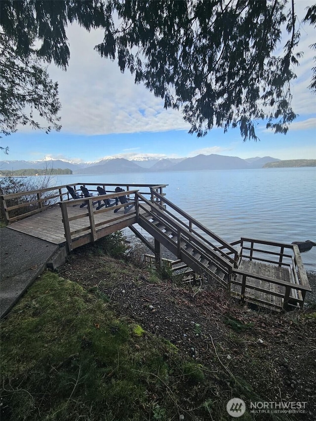 dock area featuring a water and mountain view