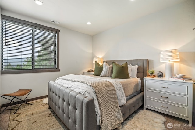 bedroom with recessed lighting, visible vents, light carpet, and baseboards