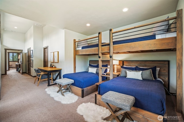 carpeted bedroom with visible vents and recessed lighting