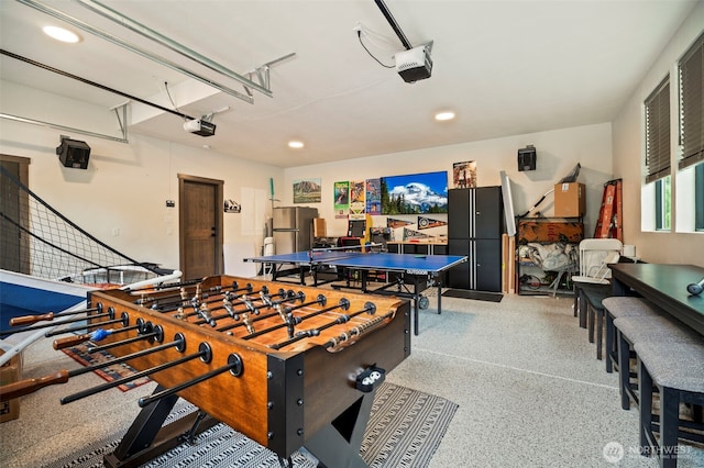 playroom featuring a garage, recessed lighting, and speckled floor