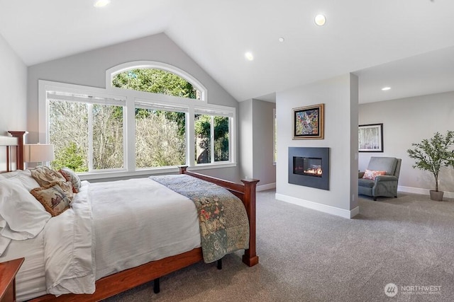 carpeted bedroom with a glass covered fireplace, lofted ceiling, baseboards, and recessed lighting