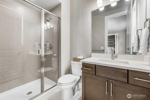 full bath with toilet, tile patterned floors, a shower stall, and vanity