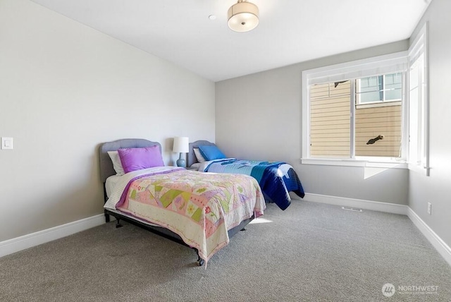 carpeted bedroom with baseboards