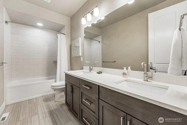 full bathroom with shower / tub combo, visible vents, a sink, and toilet