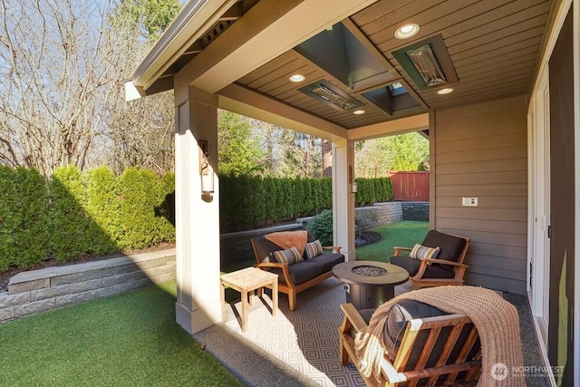 view of patio with an outdoor fire pit and fence