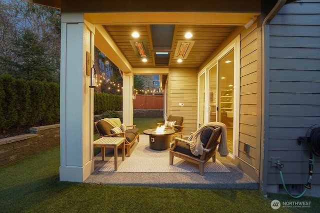 view of patio featuring fence and a fire pit