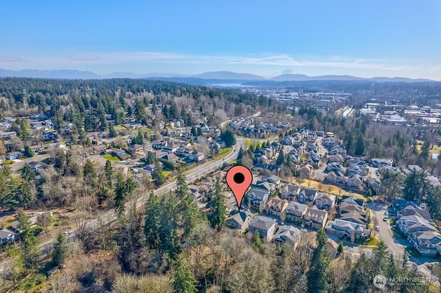 drone / aerial view with a mountain view and a forest view