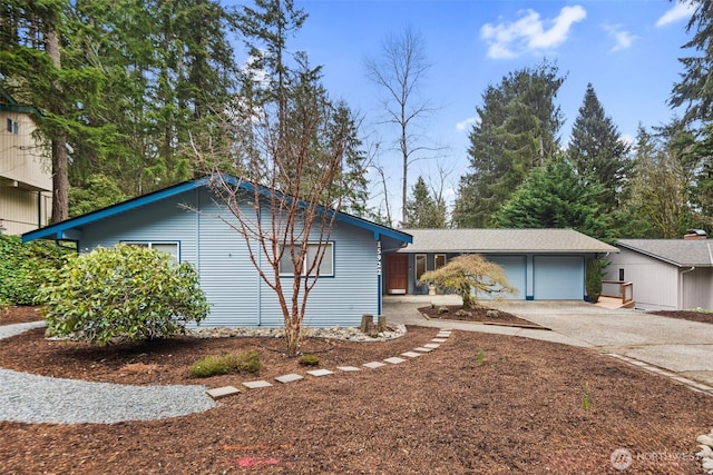 view of property exterior featuring a garage and driveway