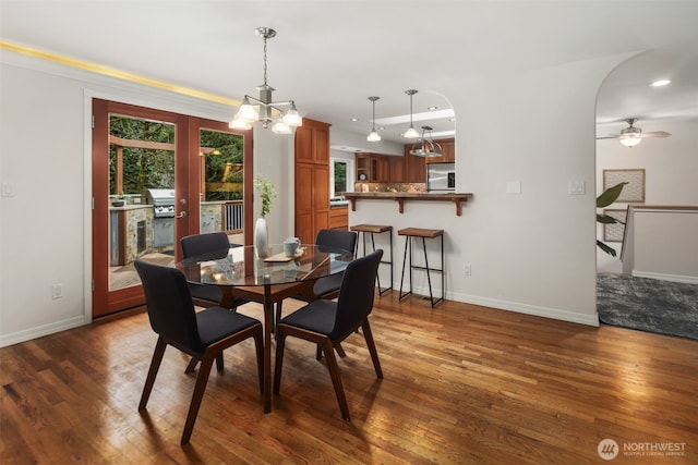 dining space with a notable chandelier, recessed lighting, baseboards, and wood-type flooring