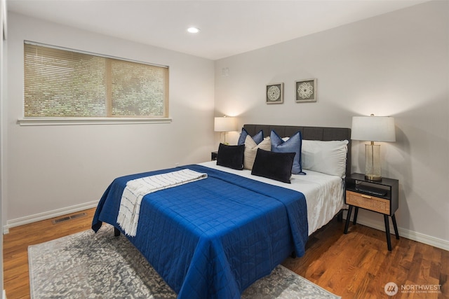 bedroom featuring recessed lighting, wood finished floors, visible vents, and baseboards