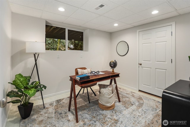 office space with recessed lighting, baseboards, visible vents, and a drop ceiling