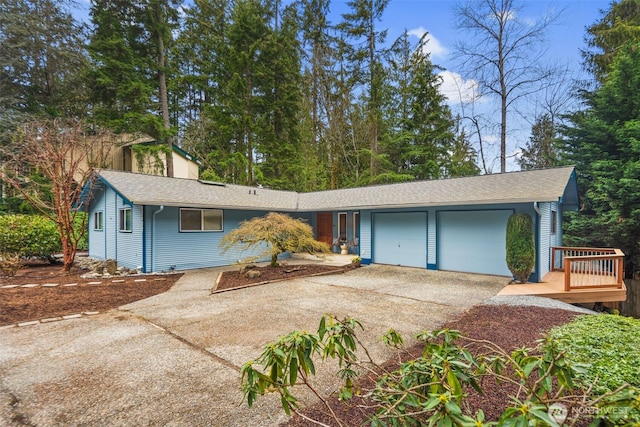 ranch-style house with an attached garage, driveway, and a shingled roof