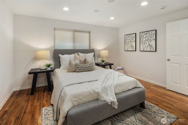 bedroom with recessed lighting, wood finished floors, and baseboards