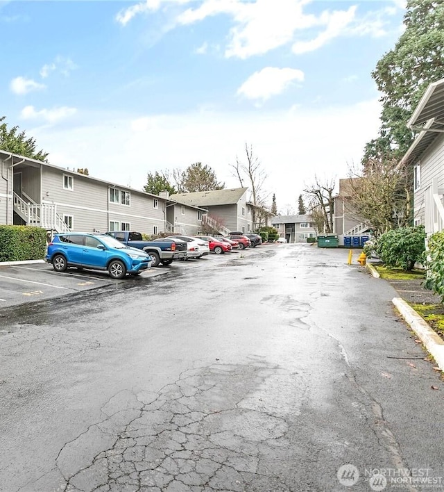 uncovered parking lot with a residential view